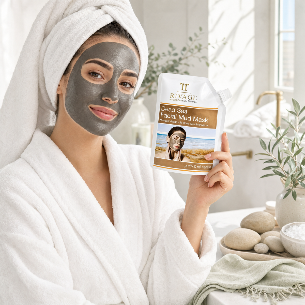 Woman wearing Rivage Dead Sea Facial Mud Mask holding the 200 g pouch