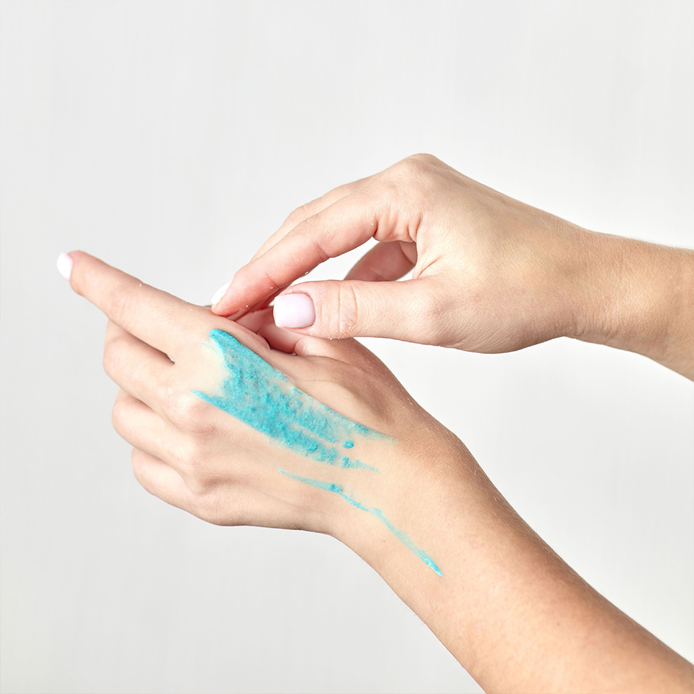 Rivage Revitalizing Body Scrub exfoliating body scrub with Dead Sea salt crystals and vitamin E for smooth and rejuvenated skin